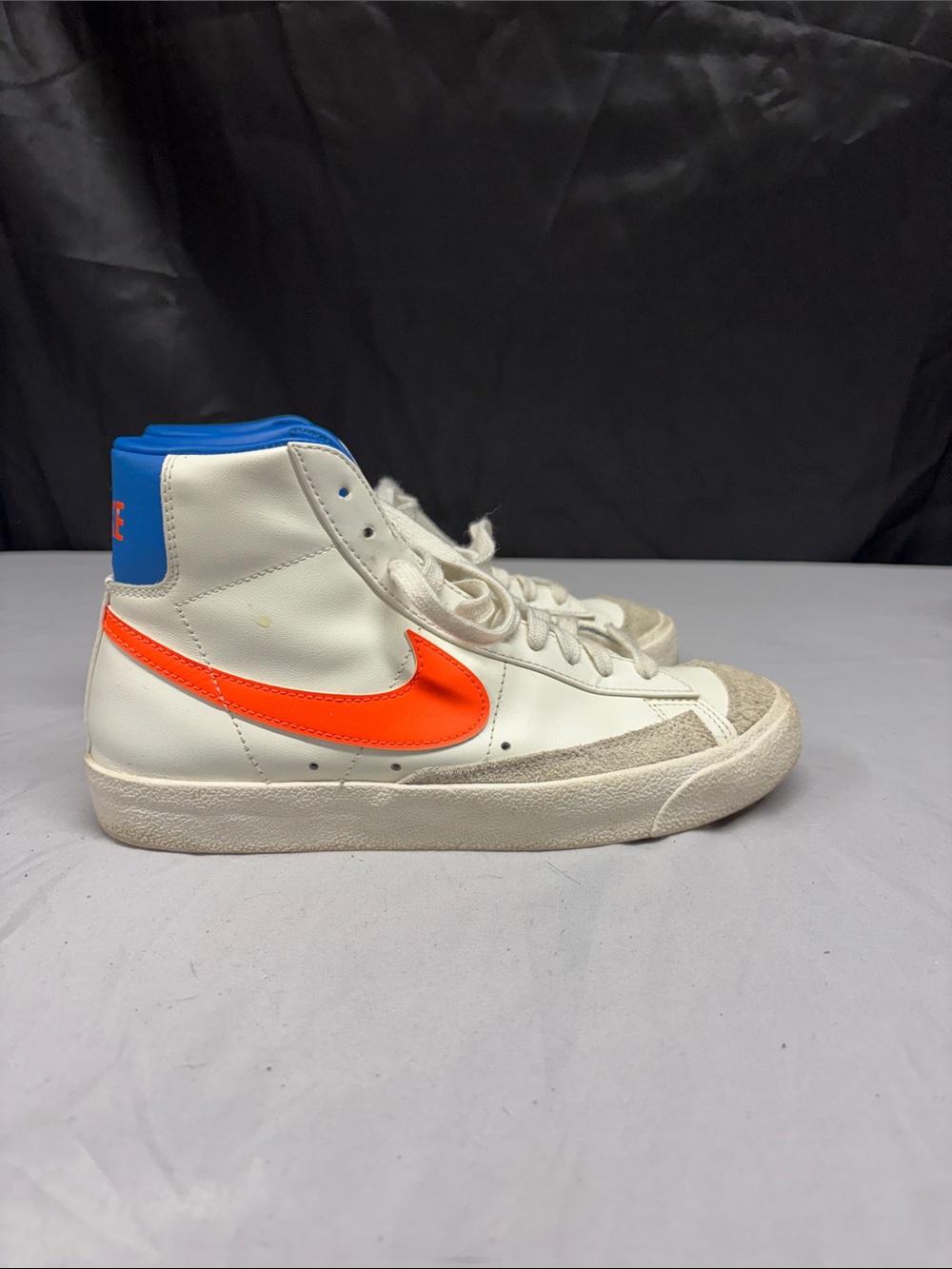 Nike White High-Top Sneakers with Orange Swoosh and Blue Collar